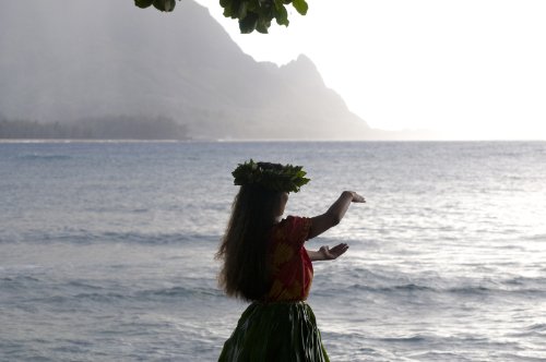 silhouette of a hula dancer dancing on the beach in Kauai at sunset